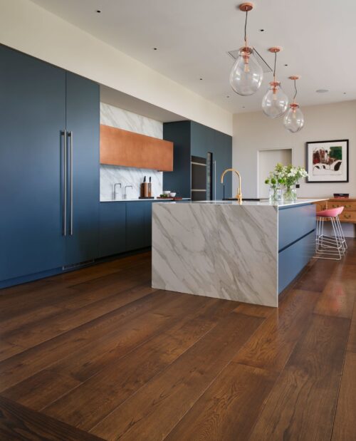 open plan kitchen showing micro bevelled oak flooring planks in a mid-dark finish colour.