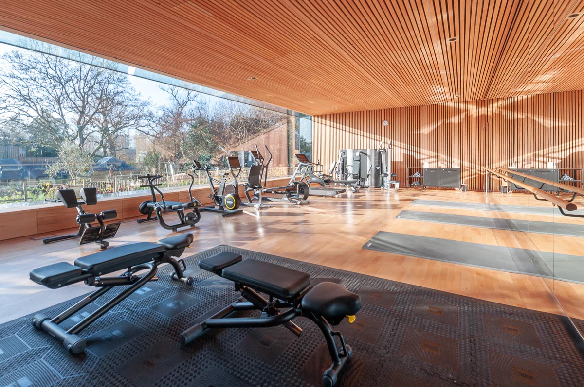 Square edged lacquered bespoke engineered oak wood flooring in private gym