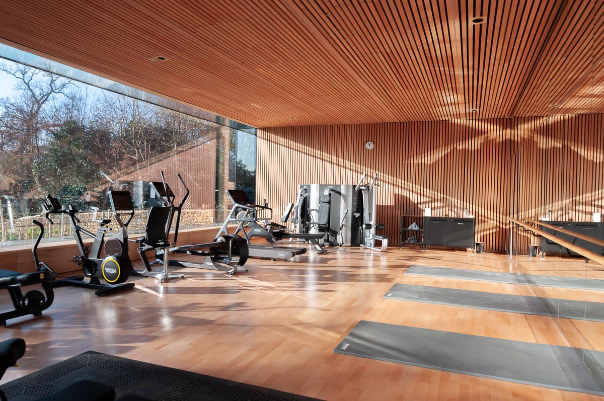 Square edged lacquered bespoke engineered oak wood flooring in private gym
