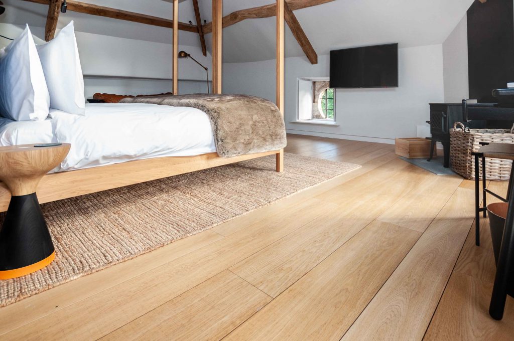 Sawn and Brushed oak flooring in bedroom at Somerset estate