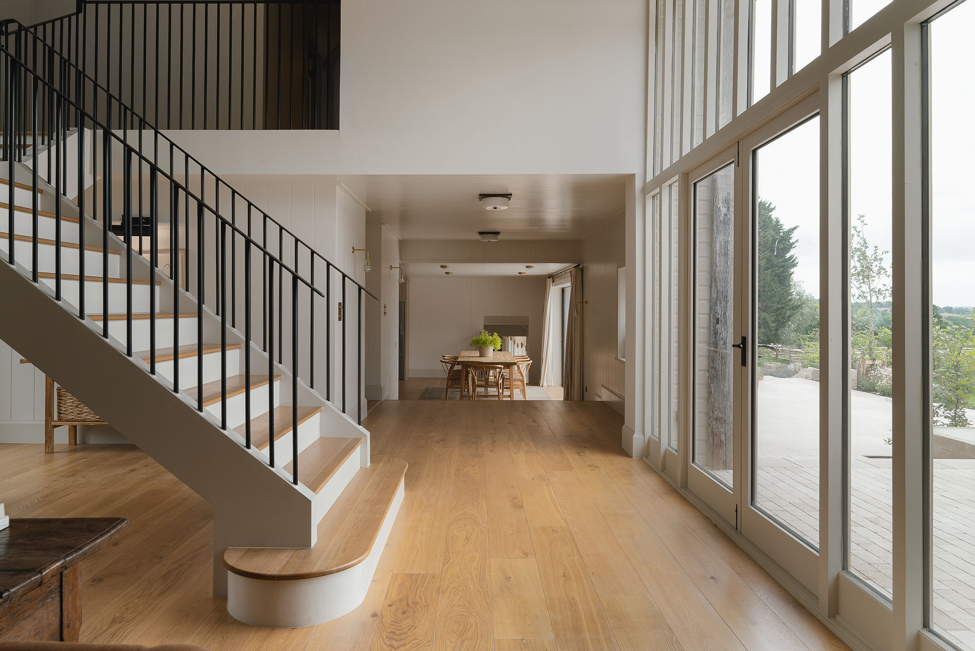 Light brushed oak flooring and stairs with Milky Coffee finish at Sussex Barn project